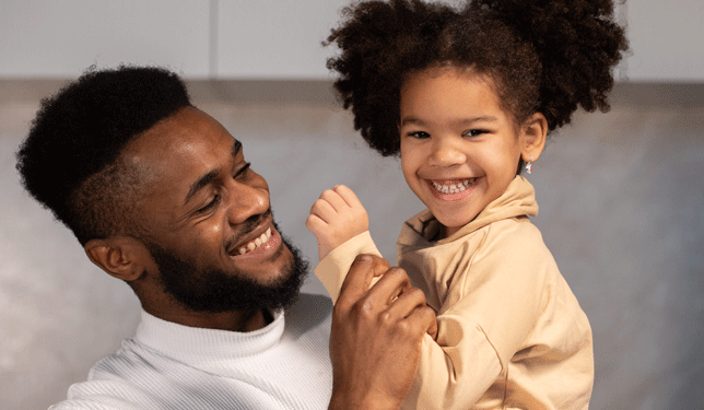 father and daughter smiling