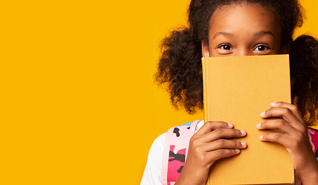 thanksgivingback little girl holding book and smiling